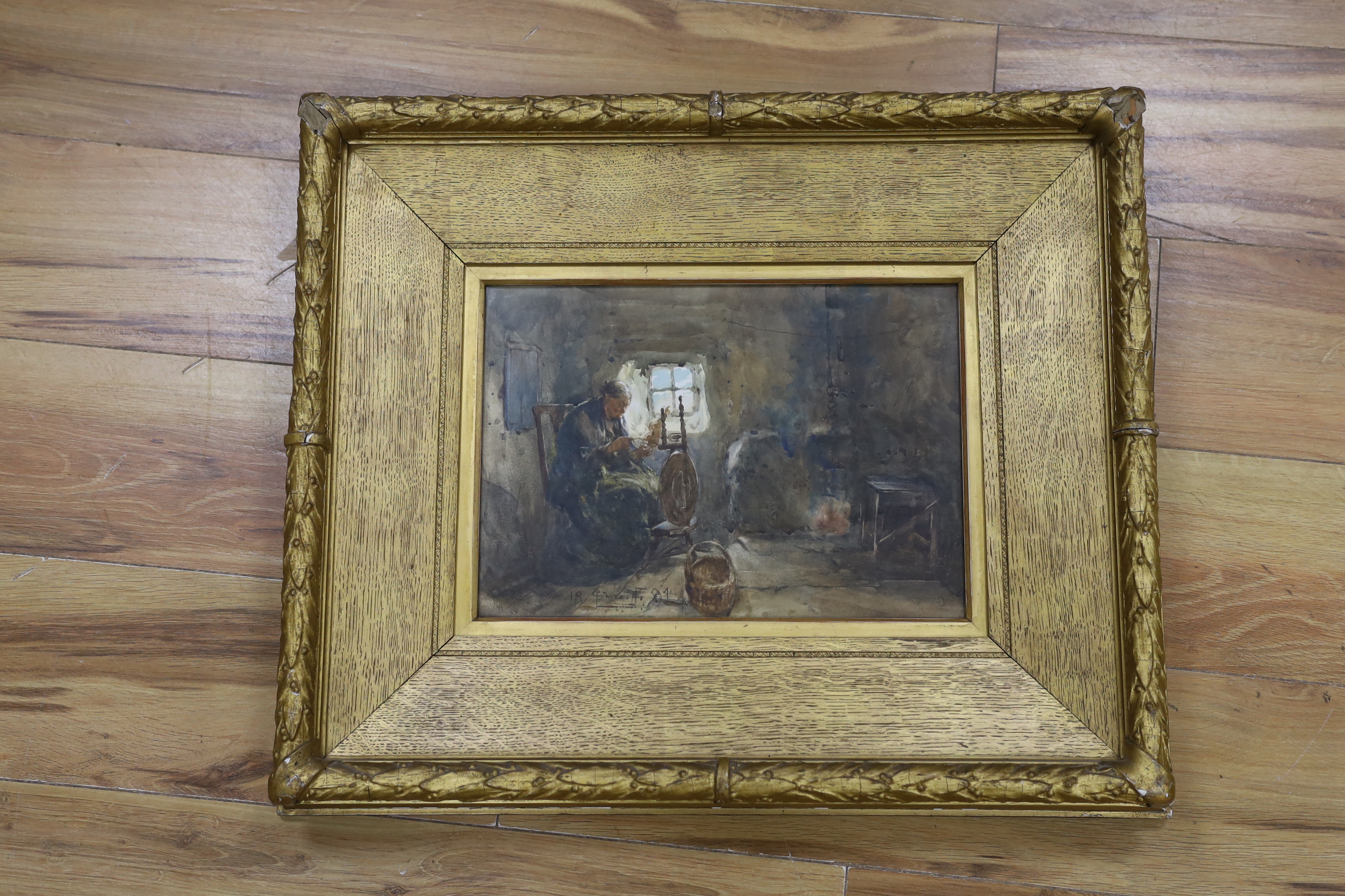Victorian School, watercolour, Interior with lady seated at a spinning wheel, indistinctly signed and dated 1894, 24 x 34cm, ornate gilt framed